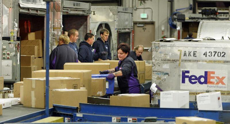 FILE - FedEx employees send out packages Monday, Dec. 10, 2012, in Salt Lake City.