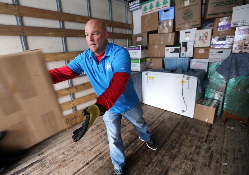 Dave Durocher, managing director of The Other Side Academy, helps move a client's home in Millcreek on Thursday, Jan. 7, 2016.