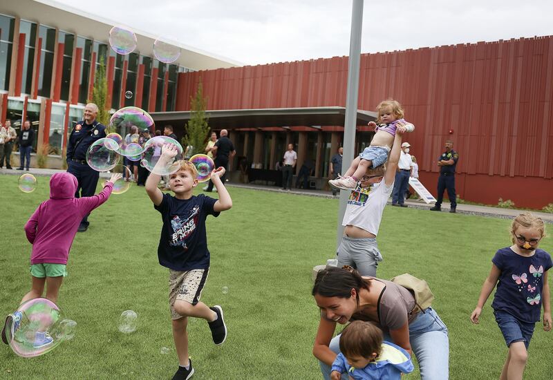 Children pop bubbles at the grand opening of the Salt Lake County Library’s Granite branch in South Salt Lake.