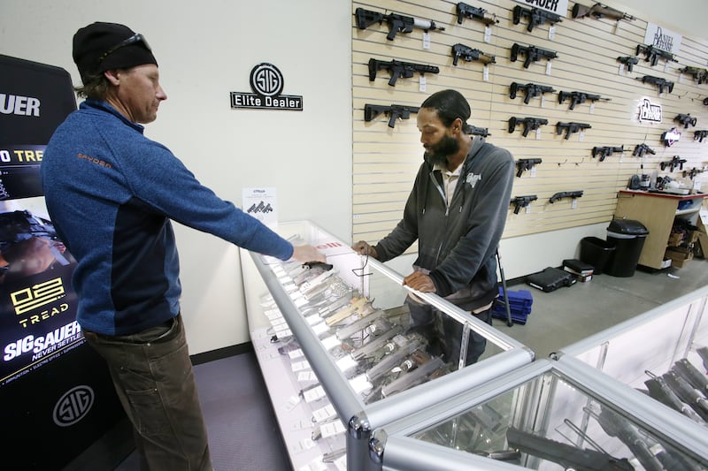 Karl Redel decides to purchase a gun for his daughters at Impact Guns in Salt Lake City on March 24, 2020. 