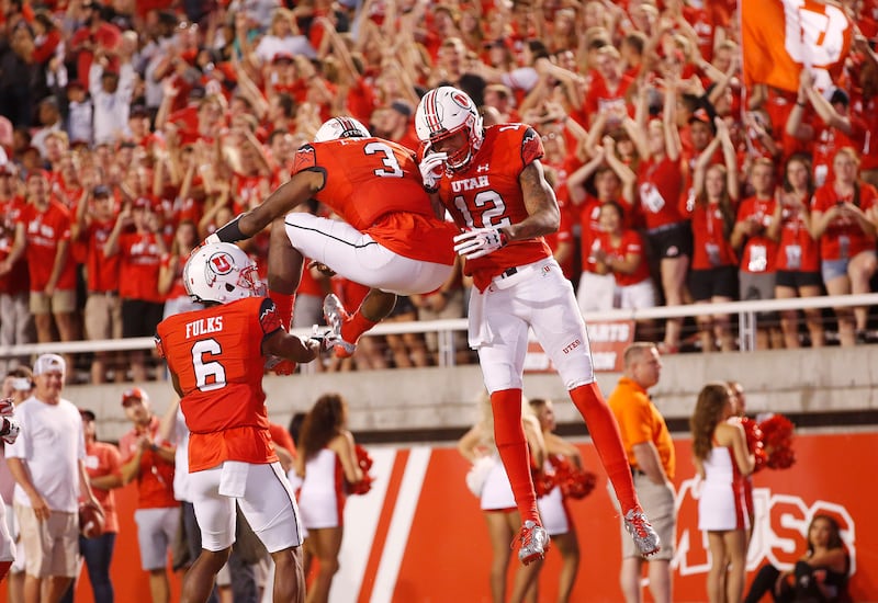 Utah Utes wide receiver Tim Patrick, wearing red, celebrates his touchdown.