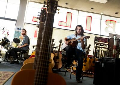 Kade Long plays percussion and Ford Harris plays guitar when they are not helping customers at Bill Harris Music in Provo on Friday, June 14, 2019.