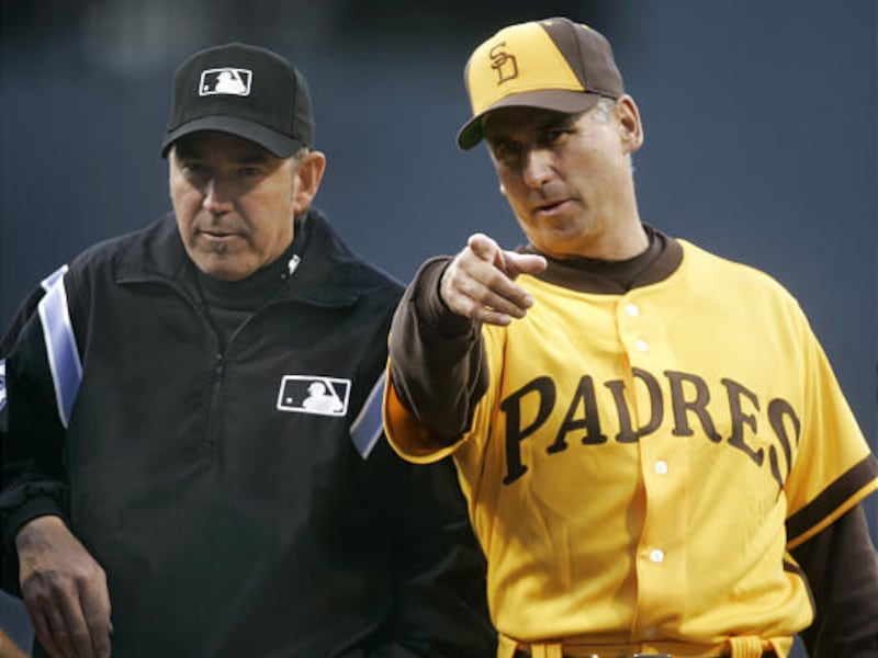 This is a May 11, 2007, file photo showing San Diego Padres manager Bud Black, right, gesturing to umpire Mike Winter while wearing the team's 1972 uniform, on retro night at PETCO Park in San Diego.
