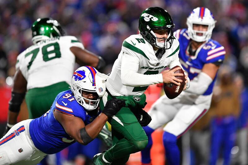 New York Jets quarterback Zach Wilson (2) is sacked by Buffalo Bills defensive tackle Ed Oliver (91) during the second half of an NFL football game in Orchard Park, N.Y., Sunday, Nov. 19, 2023.