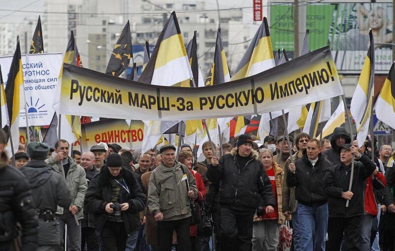 Ultra nationalist demonstrators carry an assortment of banners and flags during their authorized march on the outskirts of Moscow, Russia, Friday, Nov. 4, 2011. The new holiday, marking the end of the foreign intervention in Russia in 1612, was created in