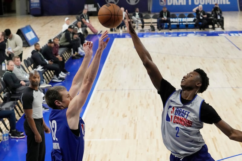 Jaxson Robinson, right, blocks a shot by Payton Sandfort during the 2024 NBA combine in Chicago, Tuesday, May 14, 2024.