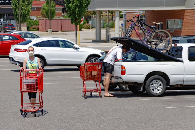 A woman and man wear COVID-19 protective masks as she pushes her shopping cart and a man loads his truck in a parking lot, Friday, July 3, 2020, in McCandless, Pa. Gov. Tom Wolf’s more expansive mask order issued this week as the coronavirus shows new signs of life in Pennsylvania and the July Fourth holiday starts has been met with hostility from Republicans objecting to the Democrat’s use of power or even to wearing a mask itself.