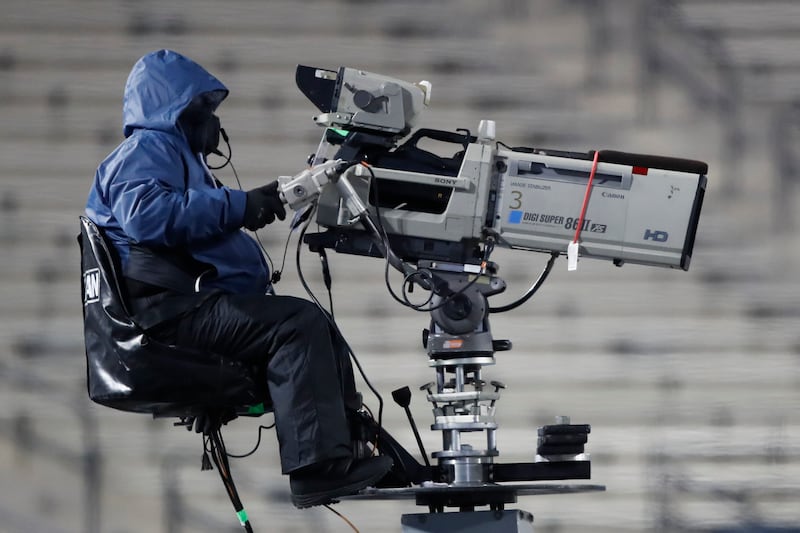 A camera man works a game in the cold against BYU and San Diego State Saturday, Dec. 12, 2020, in Provo, Utah.