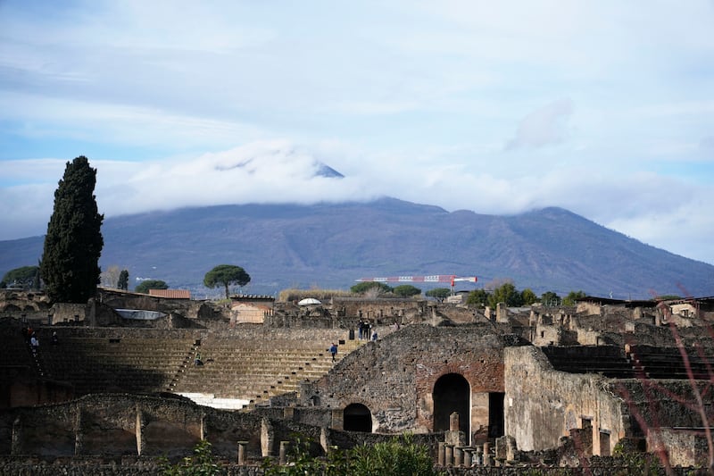 The Mount Vesuvius volcano towers over the remains of the ancient town of Pompeii in southern Italy on Feb. 15, 2022.