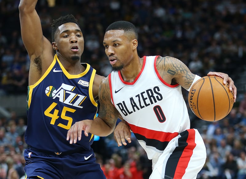Utah Jazz guard Donovan Mitchell (45) defends Portland Trail Blazers guard Damian Lillard (0) as the Utah Jazz and the Portland Trailblazers play at Vivint Arena in Salt Lake City on Wednesday, Nov. 1, 2017.