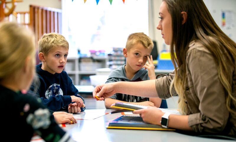 Gradee Montague and Mason Slicer listen as head teacher Sierra Westwood gives them instructions as State Superintendent of Public Instruction Sydnee Dickson sits in during a stop at her old elementary school in tiny Antimony, Utah, on Tuesday, Oct. 30, 20