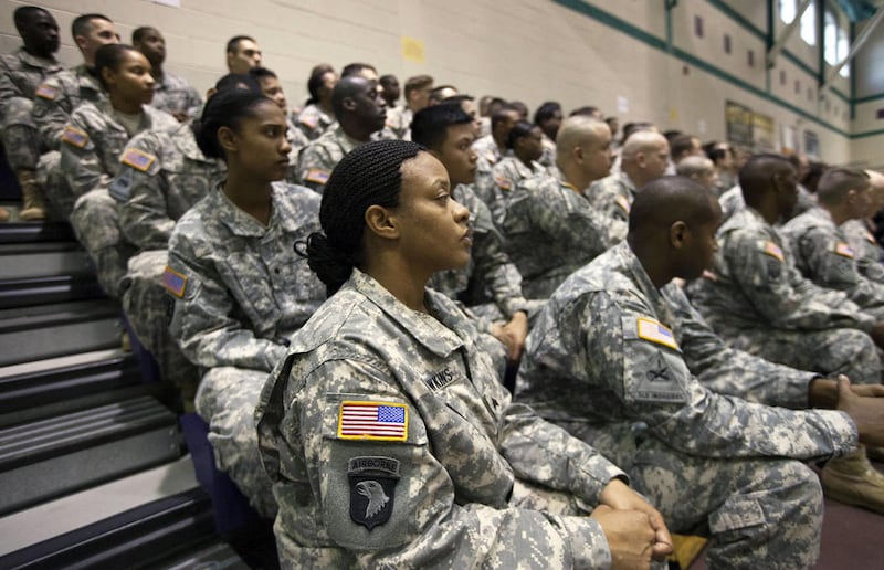 U.S. Army Sgt Dawn Hawkins, foreground, listens to Secretary of Defense Chuck Hagel speak to soldiers about the Army's future during a visit to Fort Eustis, Va., Tuesday, Feb. 25, 2014. Hagel is proposing to shrink the Army to its smallest size in three-q