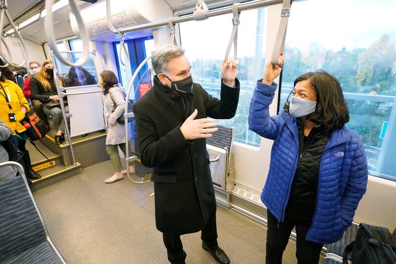 U.S. Rep. Pramila Jayapal, D-Wash., rides a Link light rail train with King County Executive Dow Constantine in Seattle.