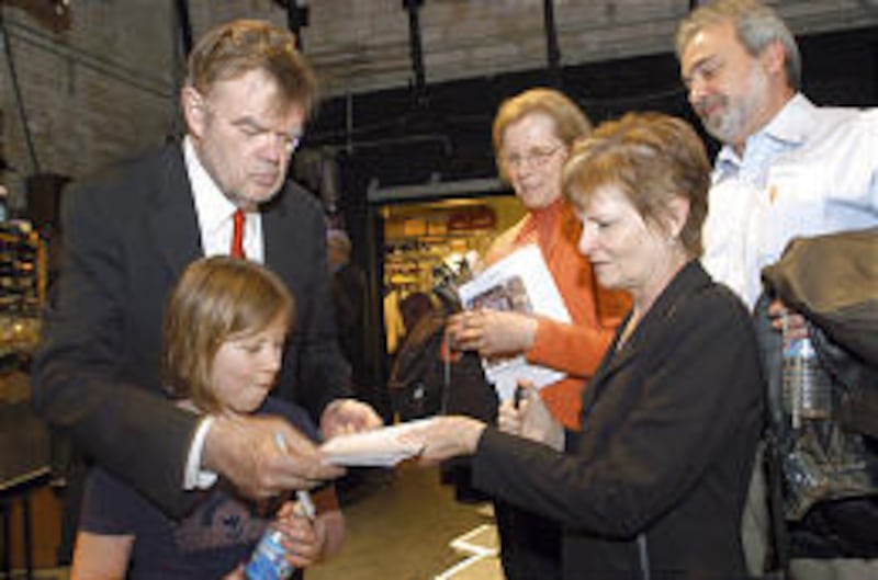 Garrison Keillor, left, hangs out with daughter Maia while signing autographs for fans after a show.