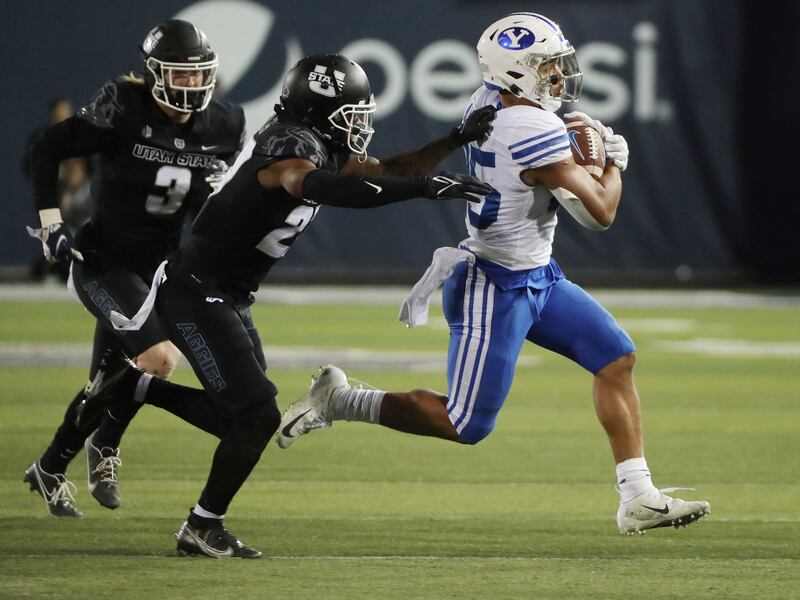 BYU’s Tyler Allgeier runs against Utah State during a game in Logan on Friday, Oct. 1, 2021.