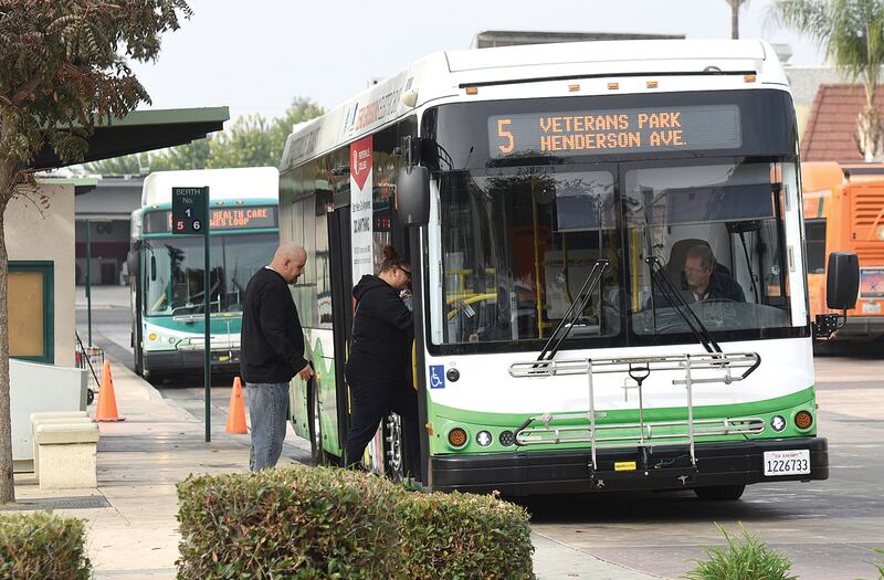 In this Nov. 16, 2018, file photo, commuters ride a new zero emission electric buses in Porterville, Calif.