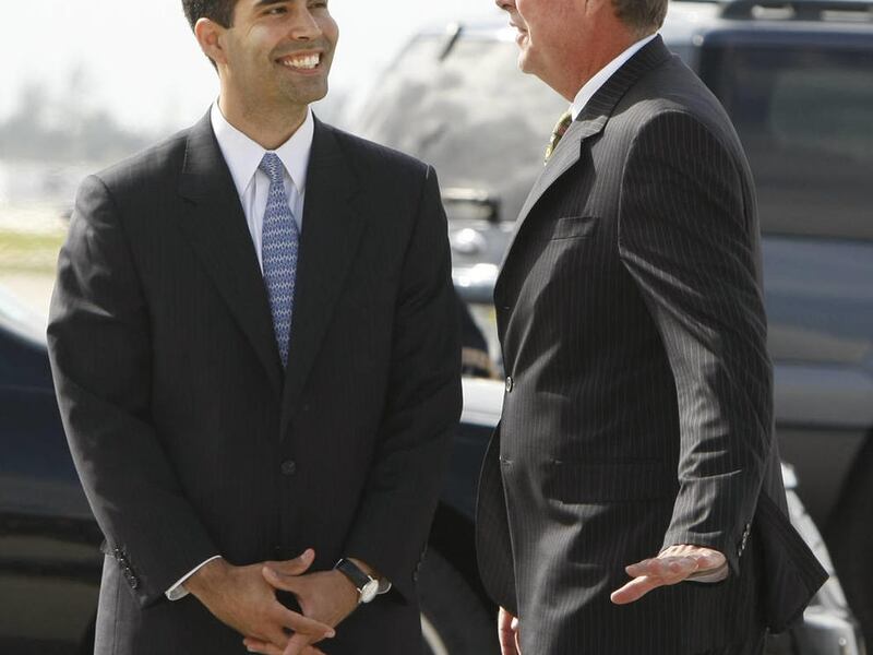 Former Florida Gov. Jeb Bush, right, talks with his son, George P. Bush, after greeting President Bush on his arrival at Palm Beach International Airport in West Palm Beach, Fla., Tuesday, March 18, 2008.