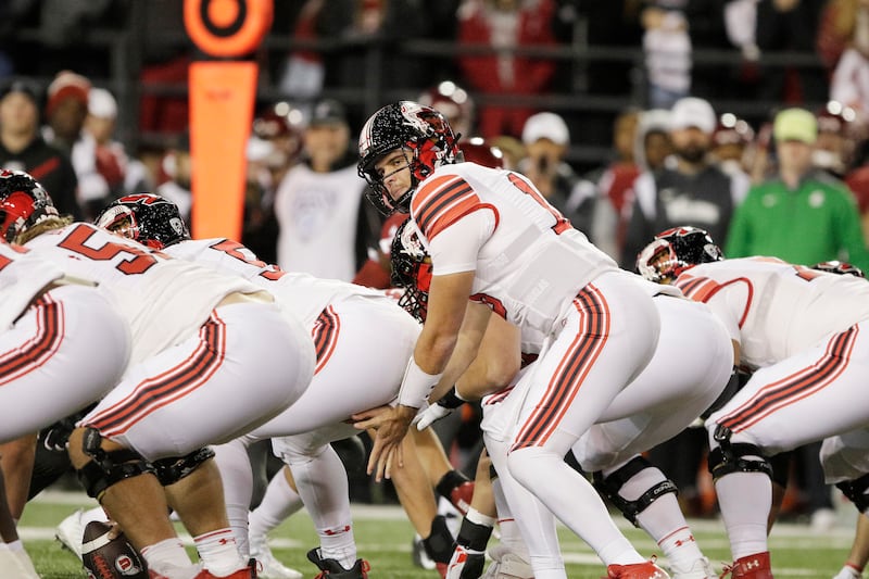 Utah quarterback Bryson Barnes, center, prepares to take a snap during the first half of an NCAA college football game against Washington State, Thursday, Oct. 27, 2022, in Pullman, Wash.
