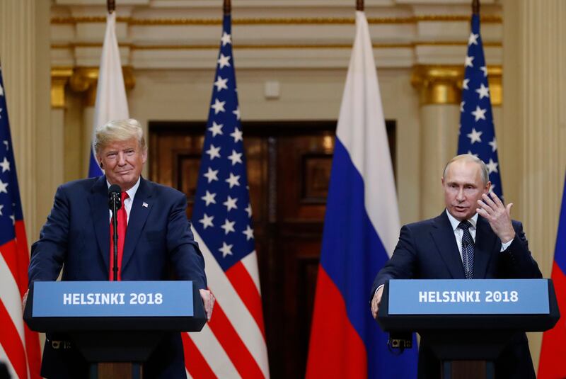 U.S. President Donald Trump, left, listens to Russian President Vladimir Putin during a press conference after their meeting at the Presidential Palace in Helsinki, Finland, Monday, July 16, 2018. (AP Photo/Alexander Zemlianichenko)