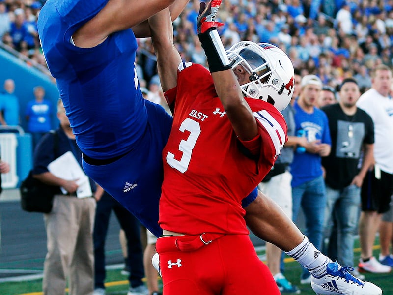 Bingham's Brayden Cosper, right, goes up for pass against East during game Friday, Aug. 25, 2017.
