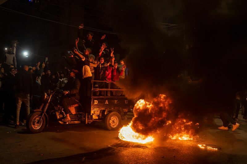 Palestinians celebrate after a shooting attack near a synagogue in Jerusalem, in Gaza City.