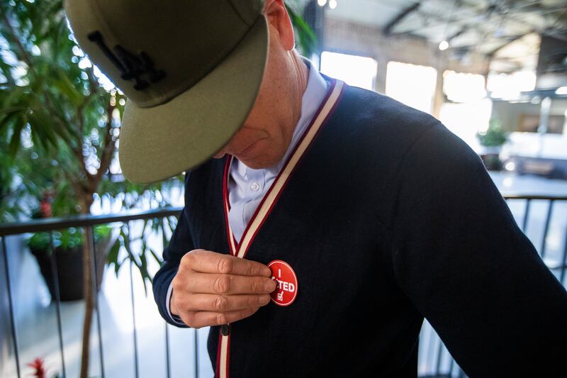 Greg Walker puts on his “I Voted” sticker after voting at a polling station at Trolley Square in Salt Lake City on Tuesday, Nov. 6, 2018.