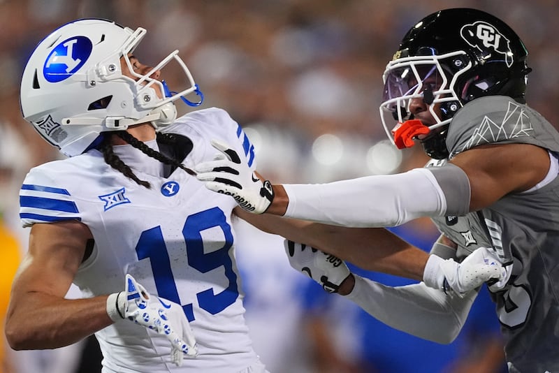 BYU receiver Tiger Bachmeier (19) and Colorado cornerback DJ McKinney (8) battle for the ball during game Saturday, Sept. 27, 2025, in Boulder, Colo.