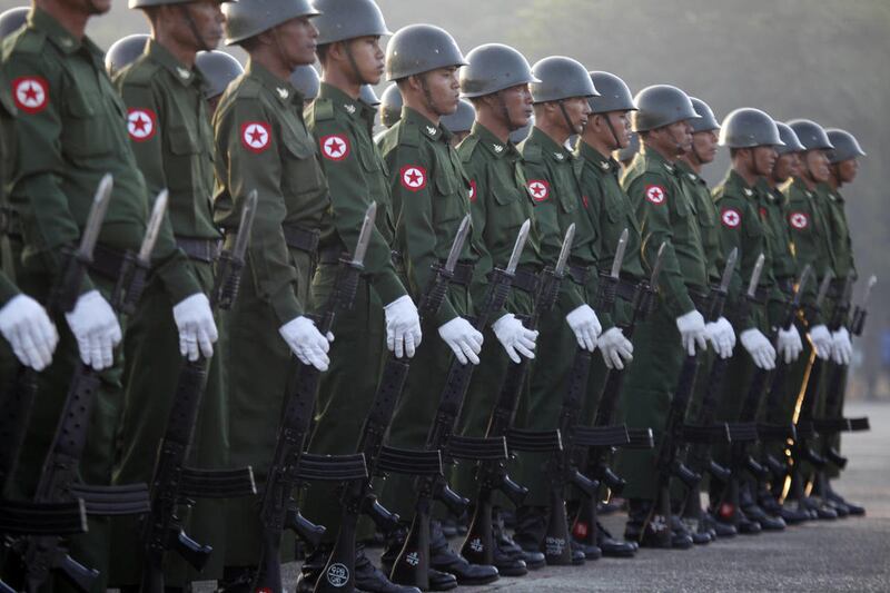A troop of Myanmar soldiers stand at attention during a flag-hoisting ceremony to mark the country 66th anniversary of the Independence Day at public square in Yangon, Myanmar, Saturday, Jan. 4, 2014. An enormous jade boulder that could weigh up to 50 ton