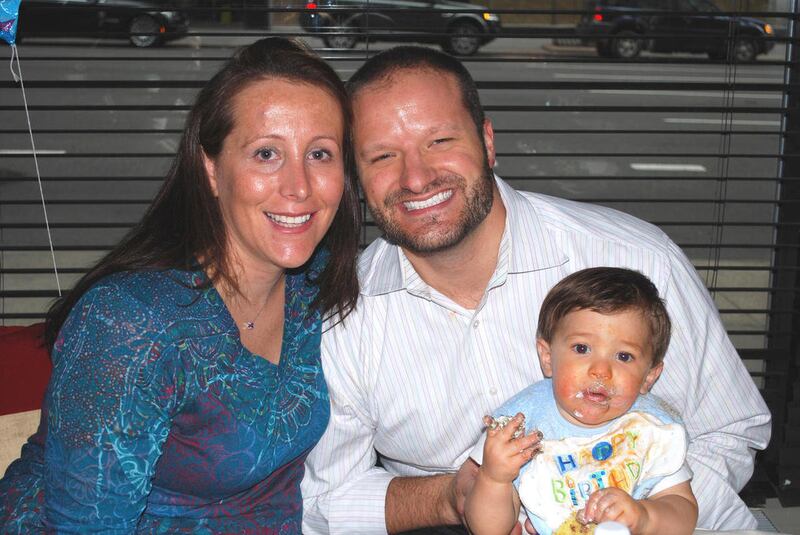 This March 2, 2011 handout photo provided by the family shows Dianna Fiore Radoslovich of New York, with her husband Steve and son Steven Andrew, celebrating his first birthday. Radoslovich's multiple sclerosis symptoms _ including difficulty walking _ te