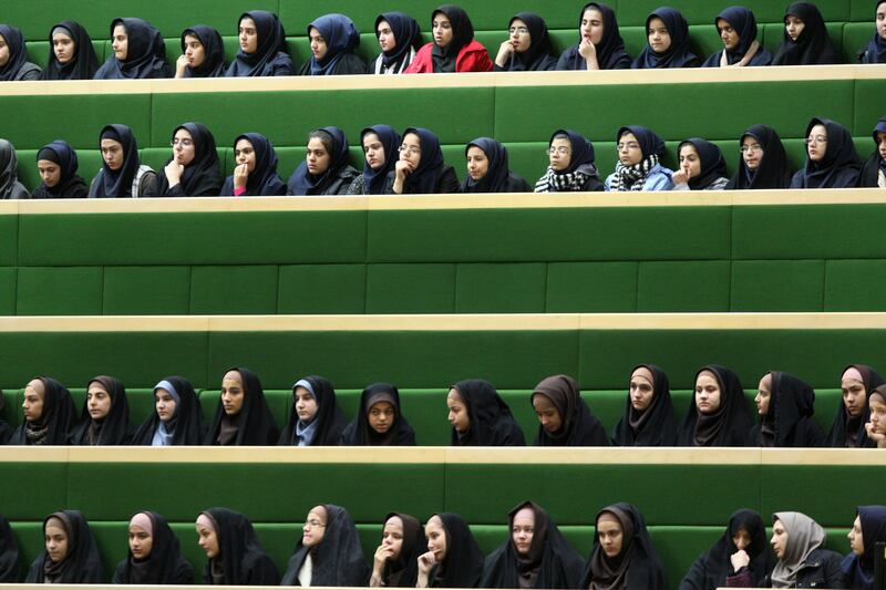 Iranian schoolgirls follow the debates of parliament, in Tehran, Iran, Sunday, Nov. 27, 2011. Iran is investigating hundreds of cases of Iranian school girls possibly being poisoned.