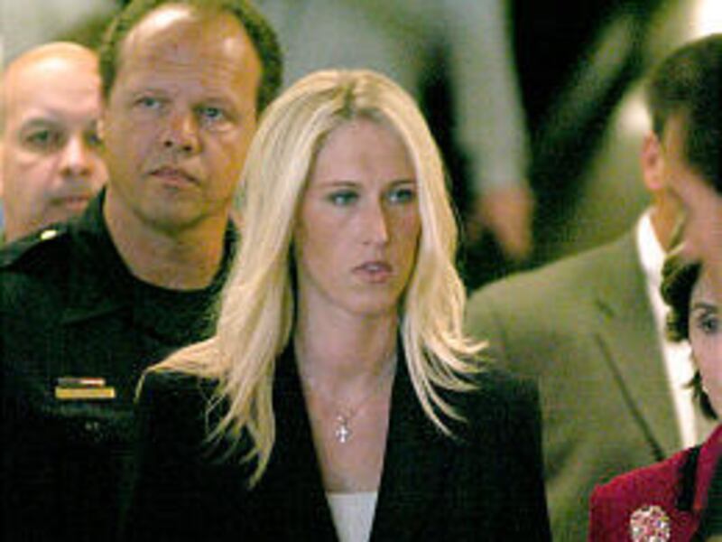 Amber Frey leaves court in Redwood City, Calif., Tuesday. She testified that Scott Peterson had told her he was unmarried.