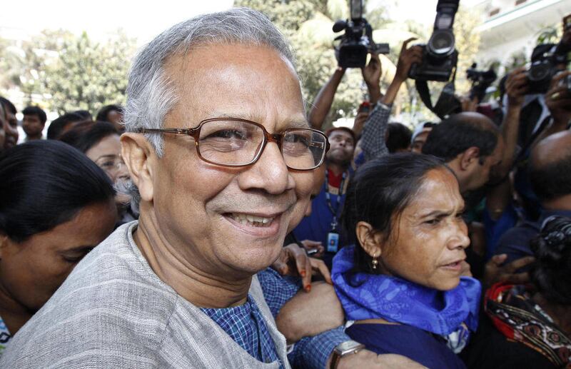 FILE - In this March 3, 2011 file photo, Bangladeshi Nobel laureate Muhammad Yunus smiles as he arrives at the High Court in Dhaka, Bangladesh. Just before the global financial crisis struck in 2008, Yunus came to the U.S. to do just about the last thing