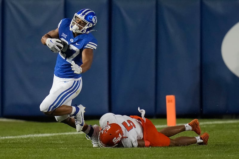 Sam Houston defensive back David Fisher tackles BYU running back LJ Martin Saturday, Sept. 2, 2023, in Provo, Utah.