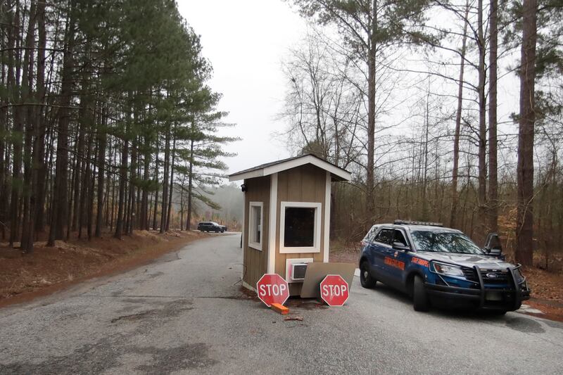 A Georgia State trooper guards an area of Hard Labor Creek State Park Wednesday, March 11, 2020, in Rutledge, Ga. The state is using the park to locate emergency mobile units to quarantine people who may have been exposed to the coronavirus. Currently, one person who tested positive for the virus is being isolated at the park, according to a statement from Gov. Brian Kemp. (AP Photo/John Bazemore)