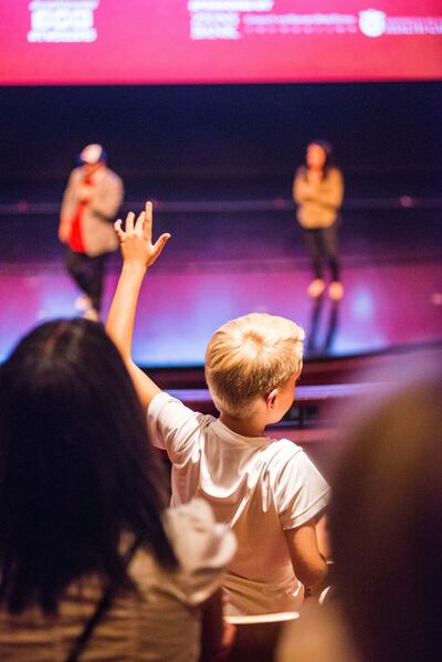 A child raises his hand to participate in a Q&A at the Tumbleweeds Film Festival.