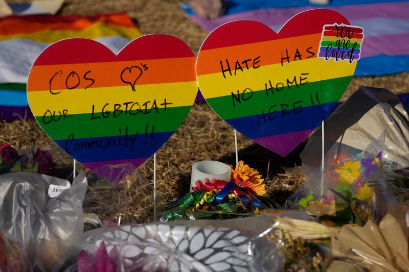 Signs bear messages of support in a memorial to the victims of a mass shooting at a gay nightclub in Colorado Springs, Colo.