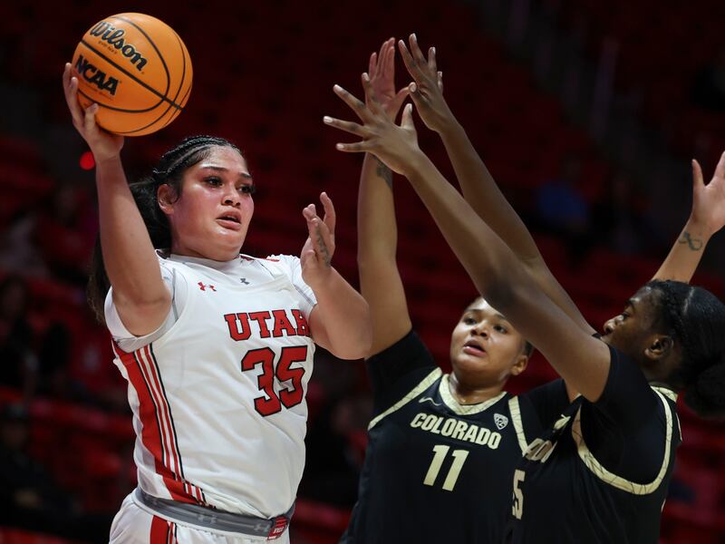Utah Utes forward Alissa Pili (35) passes the ball against Colorado Buffaloes center Quay Miller (11) and forward Brianna McLeod (25) at the Jon M. Huntsman Center in Salt Lake City on Wednesday, Dec. 14, 2022.