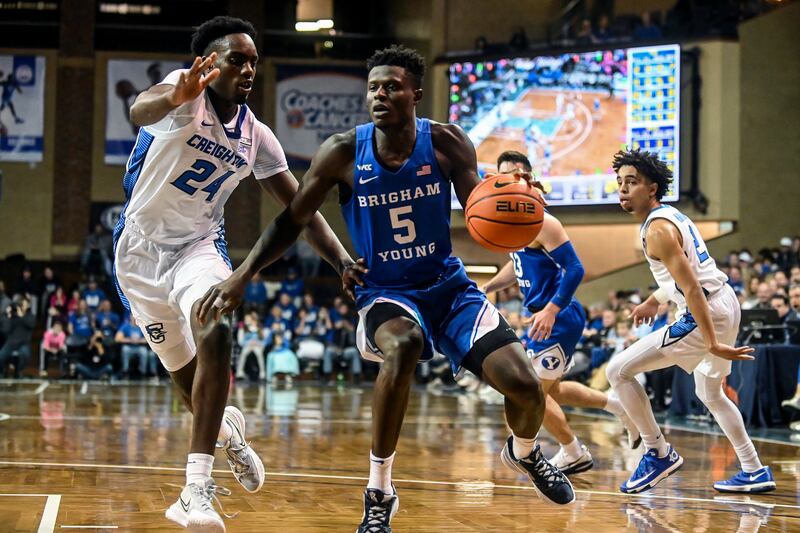 BYU’s Gideon George (21) drives to the basket as Creighton’s Arthur Kaluma (24) defends during a game at the Sanford Pentagon in Sioux Falls, S.D., on Saturday, Dec. 11, 2021.