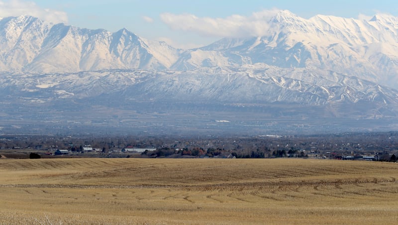 FILE - Land between 6300 West and 8500 West and 12400 South and 13100 South in unincorporated Salt Lake County, foreground, that is proposed for the Olympia Hills development on Monday, March 11, 2019. Salt Lake County leaders have their eyes set on about