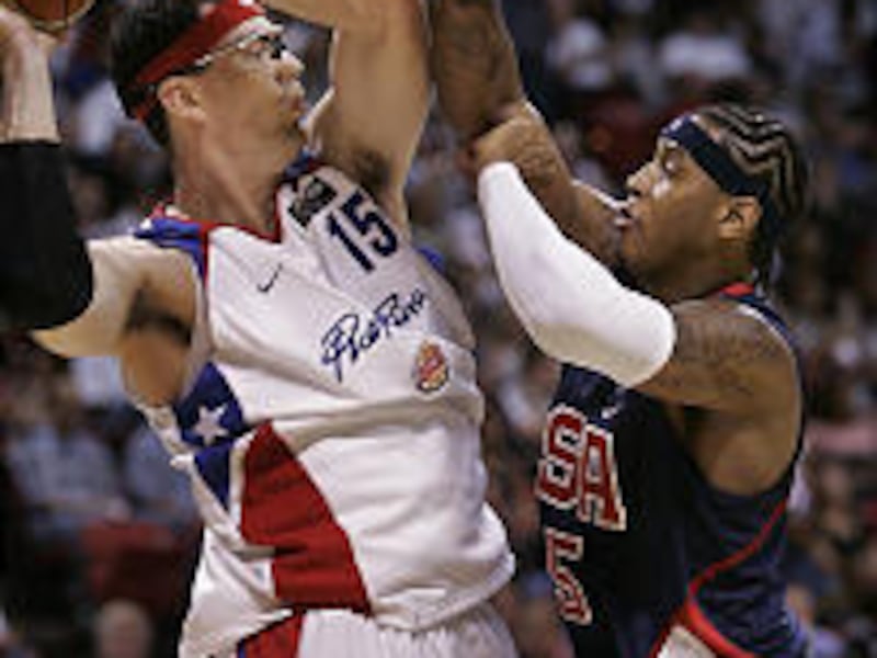 Puerto Rico's Daniel Santiago, left, tries to pass around Carmelo Anthony of the U.S. during international basketball in Las Vegas.
