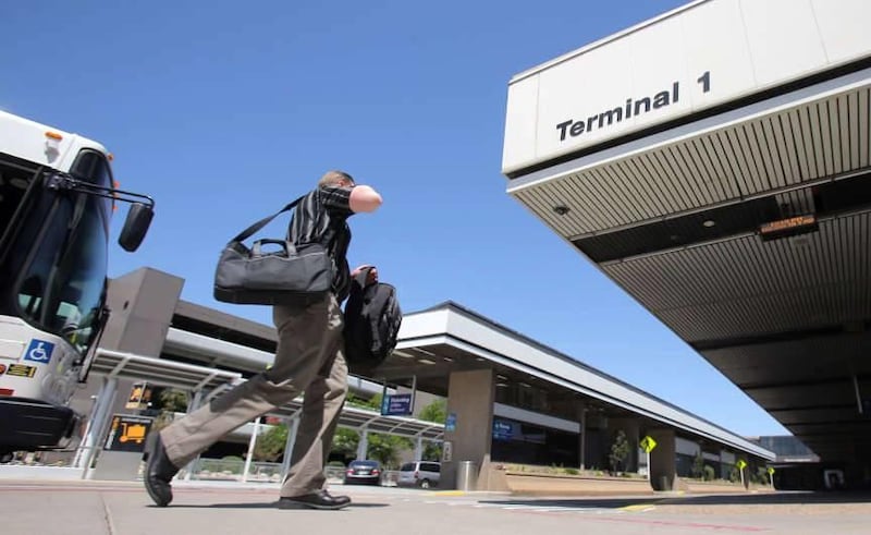 A man walks toward Terminal 1 Monday, May 19, 2014 at the Salt Lake City International Airport. The security perimeter at Salt Lake City International Airport has been breached eight times in the last decade, including once by a man who scaled a fence, br