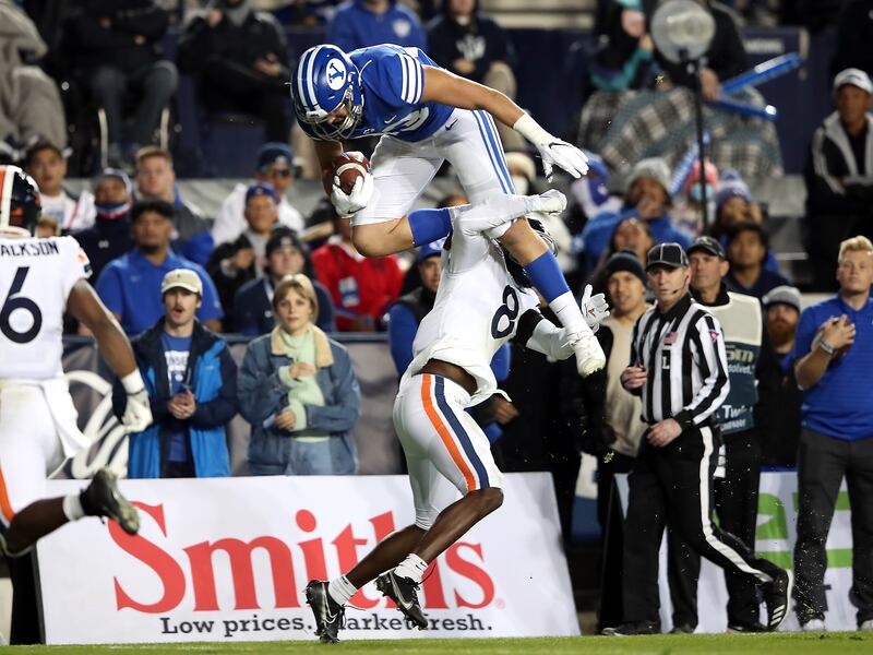 BYU’s Isaac Rex is hit by Virginia cornerback Darrius Bratton during game at LaVell Edwards Stadium in Provo, Oct. 30, 2021.