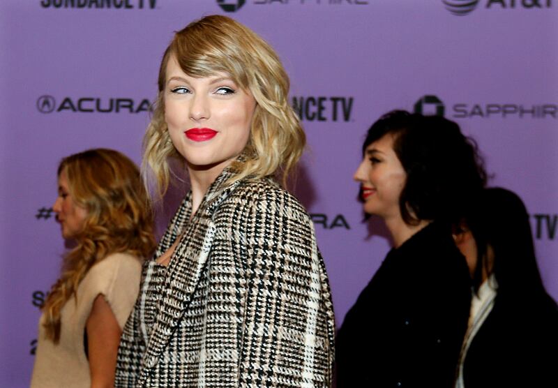 Taylor Swift poses for photos before the premiere of the documentary “Miss Americana” at the Eccles Theatre in Park City,