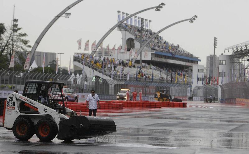 A track sweeper works on drying the track for the IndyCar's Sao Paulo 300 in Sao Paulo, Brazil, Sunday, May 1, 2011. IndyCar's race has been postponed until Monday due to heavy rains.