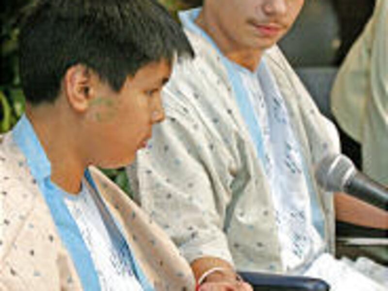 Survivors Lance Crowe, left, and schoolmate Cody Thunder await the start of a news conference Thursday. Both were shot by Jeff Weise during Monday's shooting spree.