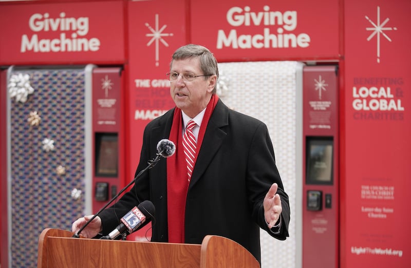 Elder Kevin W. Pearson speaks during the opening of the red Giving Machines.