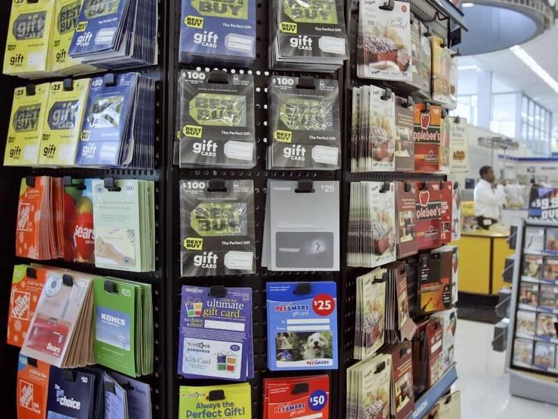 FILE - In this Jan. 10, 2008 file photo, gift cards for various retailers are offered for sale at a supermarket in Omaha, Neb. The Federal Reserve issued new rules on Tuesday, March 23, 2010, to protect Americans from getting stung by unexpected fees or r
