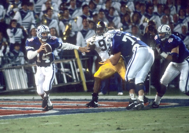 BYU quarterback Ty Detmer scrambles during 1991 Holiday Bowl against No. 7 Iowa in San Diego.