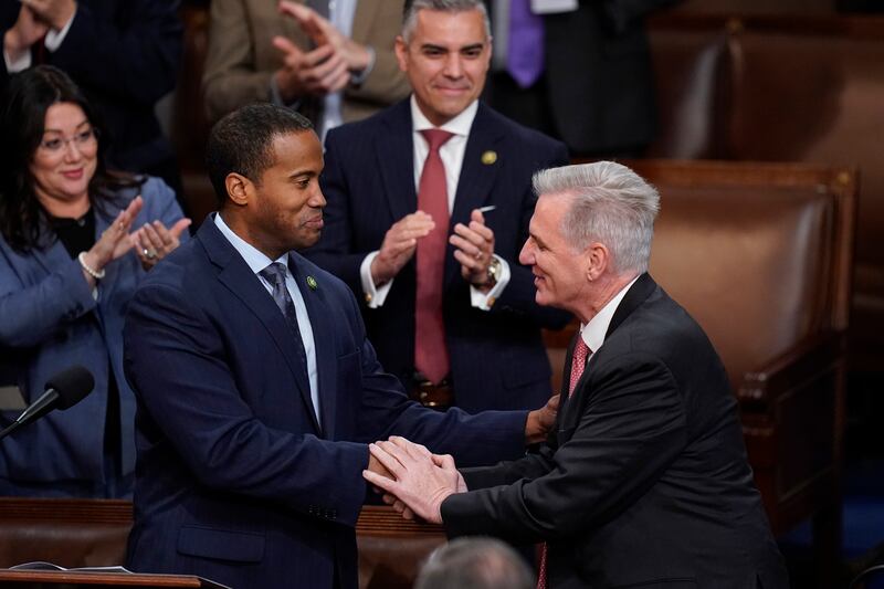Rep. John James, R-Mich., left, shakes hands with Rep. Kevin McCarthy, R-Calif., in the House chamber in Washington, Jan. 5, 2023.
