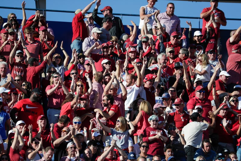 Fans of the Arkansas Razorbacks cheer after their team scored a touchdown against the BYU Cougars in Provo on Saturday, Oct. 15, 2022. The Razorbacks won 52-35.